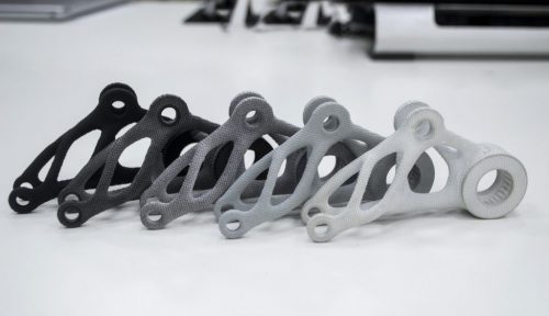 Black white gray models printed on 3D printer in laboratory office.