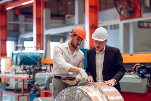 Factory worker foreman and engineer manager working together at