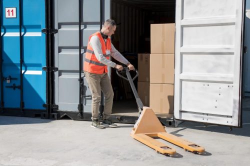 full-shot-man-carrying-pallet-truck